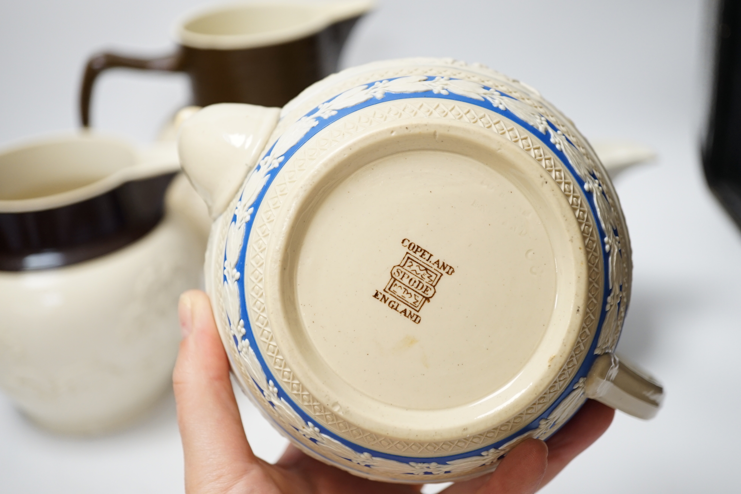 A group of Staffordshire white stonewares: five jugs and a teapot, including Adams, tallest jug 21cm high